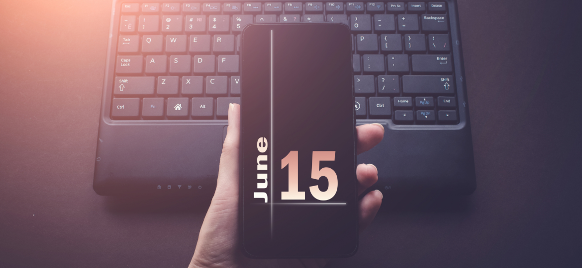phone screen showing June 15 over a laptop.