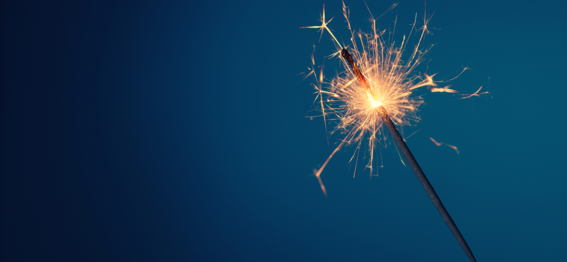 A sparkler held up against the night sky