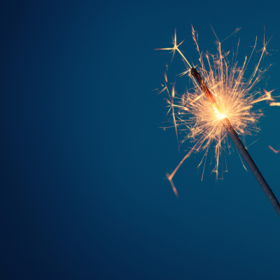 A sparkler held up against the night sky