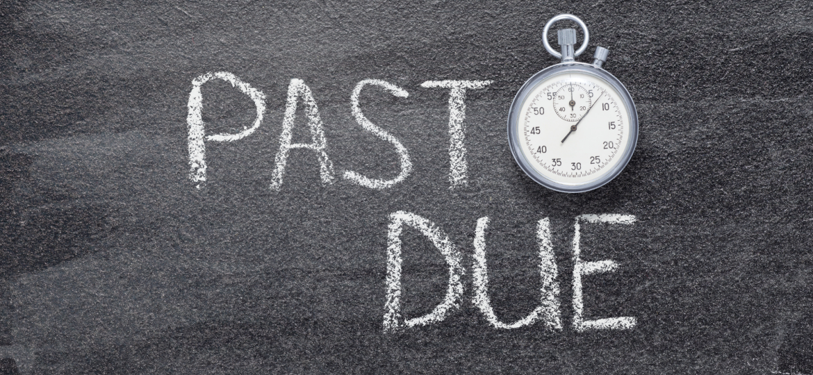 The words past due in chalk next to a stopwatch